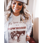 Load image into Gallery viewer, You love this tee on your kiddos and now you get to have one for yourself! Our best selling Cowhorse design is now on an adult unisex Bella Canvas tee in heather oatmeal. These tees are lightweight and comfy, perfect for wearing on hot summer days or layering underneath a button down shirt when it’s still a little chilly. www.shoplittlecoyotes.com
